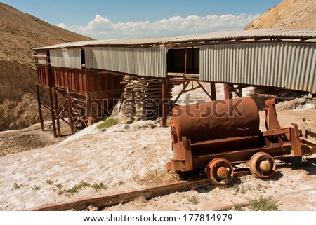 KYRGYZSTAN, CENTRAL ASIA - AUG 6: Abandoned salt mine and the rails in mountains of Central Asia under bright sun on August 6, 2013. Kyrgyzstan is ranked 70th on the Ease of doing Business Index