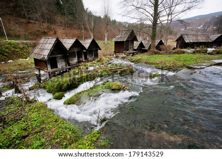 Old wooden water mills built on a fast flowing river canal in the popular ancient village near city Jajce in Bosnia and Herzegovina.