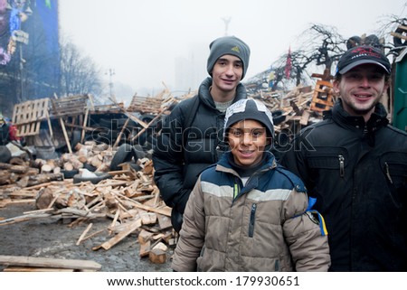 KIEV, UKRAINE - DEC 12: Unidentified kids play outdoor near the barricade during anti-government Euromaidan protest on December 12 2013. More than 800,000 protesters participated in Kiev\'s Euromaidan