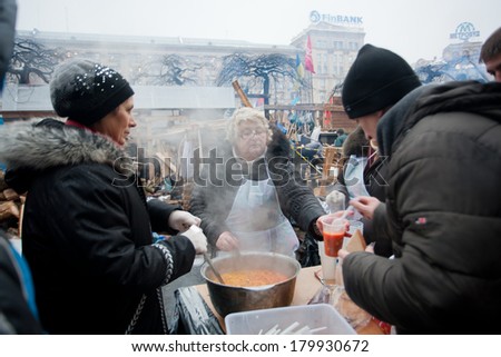 KIEV, UKRAINE - DEC 12: Elderly women cook traditional soup & distribute people on the street during Euromaidan protest on December 12 2013. More 800,000 protesters participated in Kiev Euromaidan