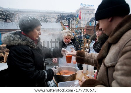 KIEV, UKRAINE - DEC 12: Women cook traditional borsch for different hungry people on the street during Euromaidan protest on December 12 2013. More 800,000 protesters participated in Kiev Euromaidan