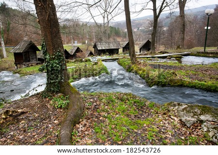 River in the forest with built wooden water mills in the popular ancient village near city Jajce in Bosnia and Herzegovina.