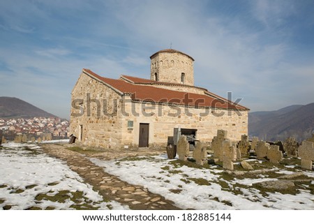 NOVI PAZAR, SERBIA - DEC 23: Rural trail to the 9th century Serbian Orthodox Church of St. Peter and a cemetery on December 23, 2013. The church was designated a UNESCO World Heritage Site in 1979