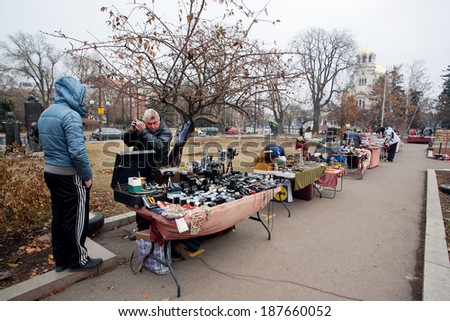 SOFIA, BULGARIA - JANUARY 2: Sellers of the open air flea market prepare or maintain items on January 2, 2013. The population of Bulgaria is 7,364,570 people according to the 2011 national census