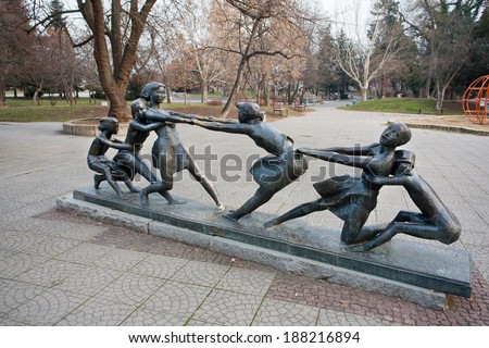SOFIA, BULGARIA - JANUARY 2: Outdoor sculpture with children entertained in the park, dragging each other. on January 2, 2013. The population of Bulgaria is 7,364,570 people.
