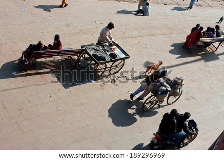 CHITRAKOOT, INDIA - DEC 29: Moving crowd of people with bikes and street food stalls at hot sunny day on December 29, 2012. Population of Chitrakoot is 22,294. By the legend, Lord Rama lived here