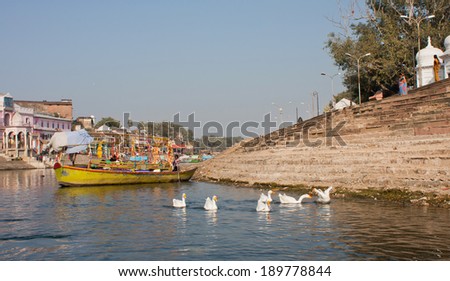MADHYA PRADESH, INDIA - DEC 28: River of the indian town with fisher boats and white birds on the water on December 28, 2012 in Chitracoot. Population of Chitrakoot is 22,294 people.