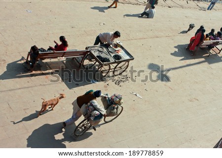 MADHYA PRADESH, INDIA - DEC 29: Shadows of the busy people on the sunny street of indian town on December 29, 2012 in Chitracoot. Population of Chitrakoot is 22,294. By the legend, god Rama lived here