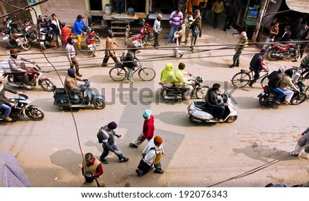 VARANASI, INDIA - JAN 4: View from above on the street traffic with crowd of people and vehicles on January 4, 2013 in indian city. Varanasi urban agglomeration has a population 1,5 million people