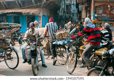VARANASI, INDIA - JAN 4: Cycle drivers try not to make an accident on the road in crazy traffic jam at the crossroads on January 4, 2013. Varanasi urban agglomeration had a population of 1,435,113