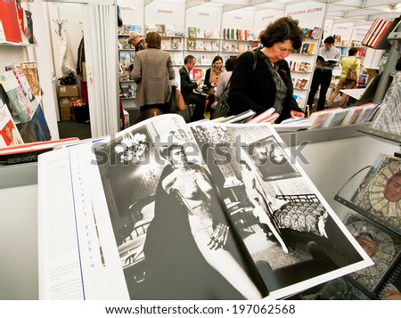 PRAGUE - MAY 15: Woman read the book of the publishing house Taschen in a book store on May 15, 2014. Association of Czech Booksellers celebrate the anniversary of the writer Bohumil Hrabal in 2014.