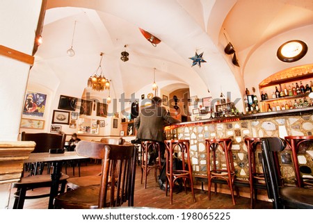 PRAGUE - MAY 17: Men sit inside the cozy restaurant with alcohol menu and long bar on May 17 2014 in Czech Republic. Fourteenth-largest city in the European Union, Prague is home to 1.3 million people