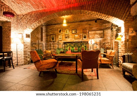 PRAGUE - MAY 16: Old fashion design room with brick walls and vintage furniture at underground of the historical building on May 16, 2014. Prague receives more than 4.4 million visitors annually