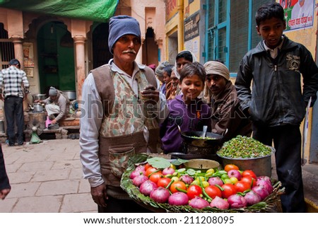 VARANASI, INDIA - JAN 4: Traditional street food seller presents a dish for everybody and passers-by people of old town on January 4, 2013. Varanasi urban agglomeration had a population of 1,435,113