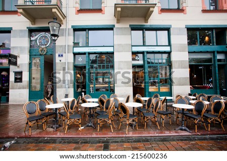 KRAKOW, POLAND - AUG 4: Old furniture outside the restaurant under the rain on August 4, 2014. Krakow with population of 800,000 people has 2.35 million foreign tourists annually