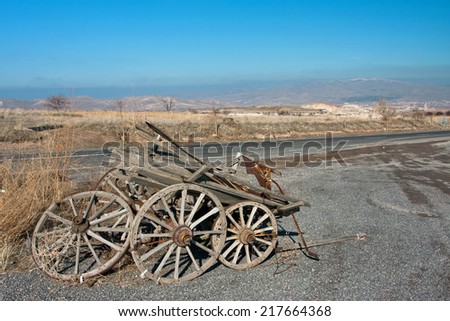 Natural landscape with wrecked and abandoned cart by the roadside in Middle East.