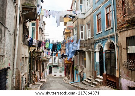 ISTANBUL, TURKEY - JAN 15: Clean clothes drying on a rope between old houses of narrow street of area Tarlabasi on January 15, 2012. Istanbul is located on area of 5,343 sq.km with popul. 13,483,052