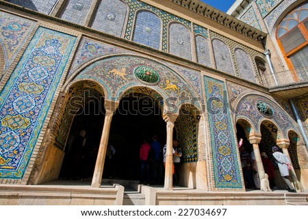 TEHRAN, IRAN - OCTOBER 6: Tourists walk inside the beautiful terrace in the Golestan Palace with persian tiles on the walls on October 6, 2014. Golestan Palace was built in 16 century, rebuilt in 1865