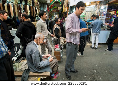 TEHRAN, IRAN - OCTOBER 6: Crowd young and elderly people earn and spend money in the bazaar on October 6 2014.