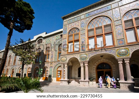 TEHRAN, IRAN - OCT 6: Crowd of tourists come from the bright persian Golestan Palace and walk to the garden on October 6, 2014. UNESCO World Heritage Site, Golestan Palace was built in 16 century.