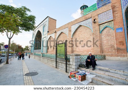 SANANDAJ, IRAN - OCT 9: Poor elderly man sells batteries and razors on the street at the brick wall of the mosque on October 9, 2014. ?apital of Kurdistan Province, Sanandaj has population of 380,000