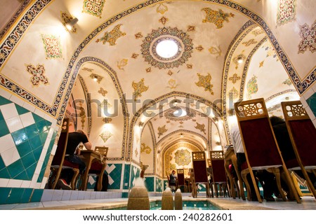 ISFAHAN, IRAN - OCT 15: Ceiling and patterned walls inside the persian restaurant with eating people inside on October 15, 2014. Third largest city in Iran, Isfahan is example of Islamic culture