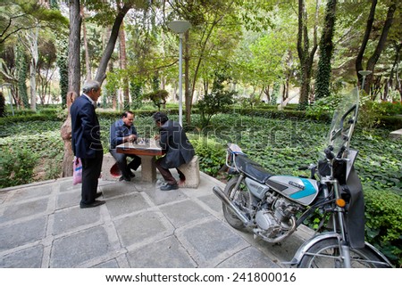 ISFAHAN, IRAN - OCT 16: Elderly men playing chess in the green park on October 16, 2014. Third largest city in Iran, Isfahan is outstanding example of Islamic culture