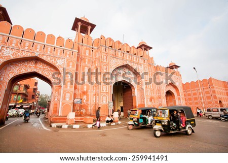 JAIPUR, INDIA - JAN 24: Auto rickshaw drive fast near the old Ajmer gate of historical Pink City wall on January 24, 2015. Jaipur, with population 6,664,000 people, is a capital of Rajasthan