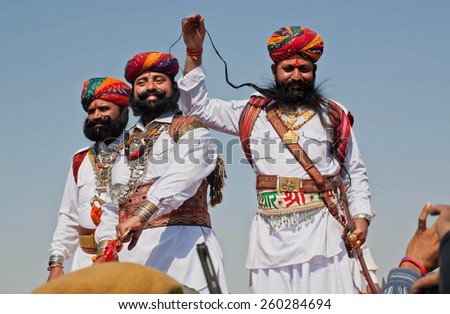 JAISALMER, INDIA - MAR 1: Best men of Rajasthan show their costumes, swords and long whiskers on the popular Desert Festival on March 1, 2015. Every winter Jaisalmer takes the famous Desert Festival