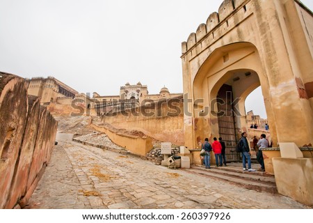 JAIPUR, INDIA - JAN 23: Open gates of the Amber Fort and tourists coming in the historical landmark on January 23, 2015 in Rajasthan. Amber Fort was built in 1592 by king Raja Man Singh.