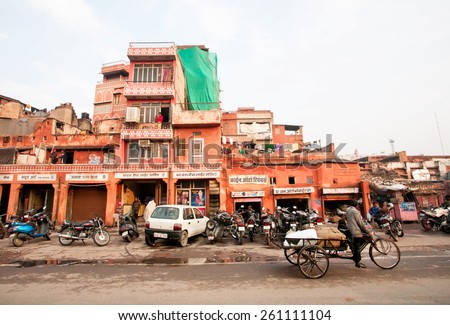 JAIPUR, INDIA - JAN 22: Poor area of historical Pink City with indian rickshaw on the dirty indian street on January 22, 2015. Jaipur, with population 6,664000 people, is a capital of Rajasthan