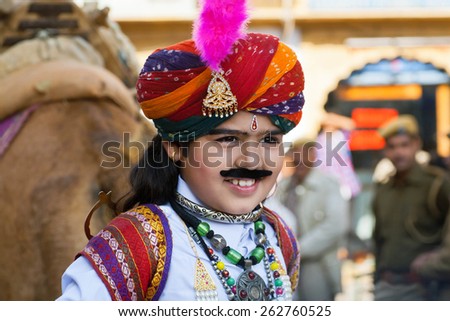 JAISALMER, INDIA - MAR 1: Unidentified child with happy face shows the beautiful indian costume on the carnaval of Desert Festival on March 1, 2015. Every winter Jaisalmer takes the Desert Festival