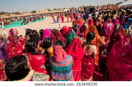 JAISALMER, INDIA - MAR 1: Wide view of the crowd of women waiting for the presentation and show on the Desert Festival on March 1, 2015 in Rajasthan. Every winter Jaisalmer takes the Desert Festival