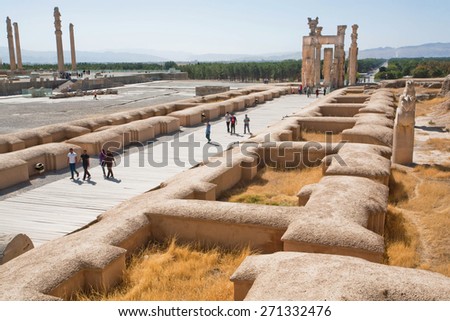 PERSEPOLIS, IRAN - OCT 22: Group of people come in area of destroyed city Persepolis on October 22, 2014. UNESCO declared citadel of Persepolis a World Heritage Site in 1979