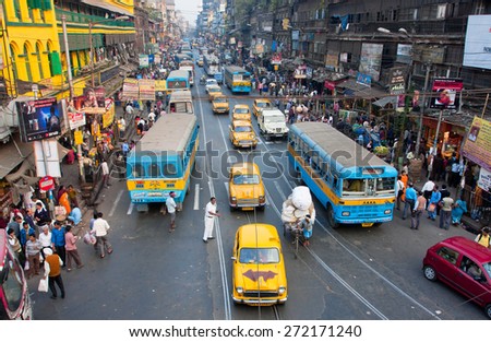KOLKATA, INDIA - JAN 13: Antique yellow Ambassador taxi cabs down the busy street on January 13, 2013 in West Bengal. First Ambassador was produced by the Yellow Cab Manufacturing Company in 1921