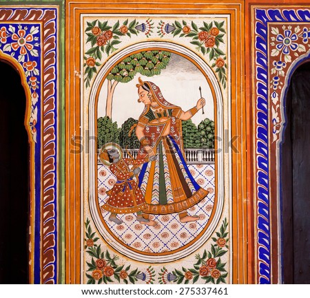 NAWALGARH, INDIA - FEB 6: Small Lord Krishna with mother on the wall mural of the old house on February 6, 2015. With population of 100,000, Nawalgarh is the education center of Shekhawati region