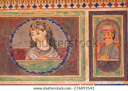 MANDAWA, INDIA - FEB 7: Lady with flower and man in a hat on a rustic fresco by unknown artist on February 7, 2015. With populat. of 21000, Mandawa is a touristic site with its naive art Haveli houses