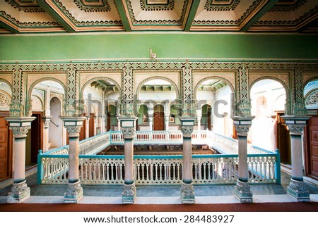 NAWALGARH, INDIA - FEB 6: Columns inside the colorful historical mansion of rich indian family on February 6 2015 in Rajasthan. With pop. of 100,000, Nawalgarh is education center of Shekhawati region