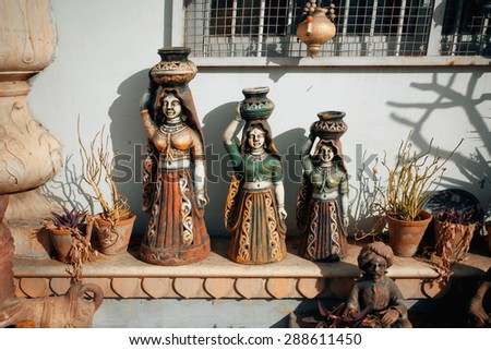 JAIPUR, INDIA - FEB 6: Vintage figurines of Indian women carrying water in jars on February 6, 2015. Jaipur, with population 6,664000 people, is a capital of Rajasthan