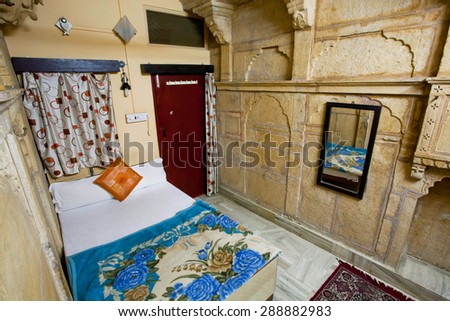 JAISALMER, INDIA - MAR 1: Poor interior design of a single room with a clean bed an indian hotel on March 1, 2015. Jaisalmer lies in the heart of the Thar Desert and has a population of about 78,000.