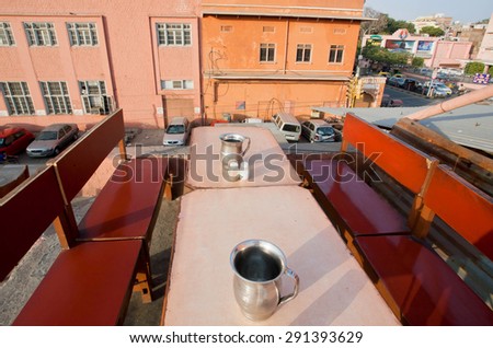 JAIPUR, INDIA - FEB 21: Jugs with drinking water on tables of cheap roof restaurant in indian city on February 21, 2015. Jaipur, with population 6,664000, is a capital of Rajasthan