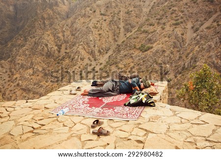 HAWRAMAN, IRAN - OCT 10: Two kurdish men sleeping over a precipice in old mountaine village on October 10, 2014 in Middle East. Islamic Republic of Iran is the world\'s 17th most populous nation