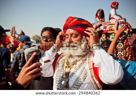 JAISALMER, INDIA - Feb 1: Elderly fashion model with white beard and mustache in Rajput costume ready for the Desert Festival on February 1, 2015. Every winter Jaisalmer takes famous Desert Festival