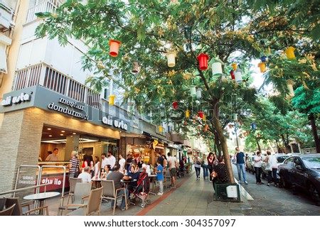 ISTANBUL - JULY 23: Visitors of outdoor cafe have breakfast in the shade of trees with homemade street lanterns on July 23, 2015. With popul. of 14.4 million, Istanbul is the 5th largest city in world