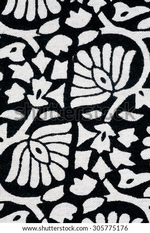 Floral pattern on black and white tablecloth in vintage hand-made style of stamping ink in India