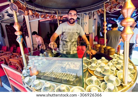 ISTANBUL - JULY 24: Tea maker from street cafe calling customers to to quench the thirst on July 24, 2015 in Turkey. With populat. of 14.4 million, Istanbul is the 5th largest city in world