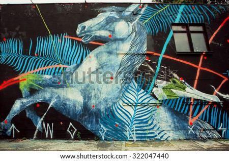 BERLIN, GERMANY - SEP 4: Wild horse by unknown artist on rustic street wall with graffiti on September 4, 2015. Urban area of Berlin comprised about 4 million people, 7th most populous in EU