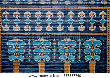 BERLIN, GERMANY - SEPT 2, 2015: Ceramic coating with images of trees and patterns on the historical wall of Babylon on Septemper 2, 2015. Artifact saved by Pergamon Museum in Berlin