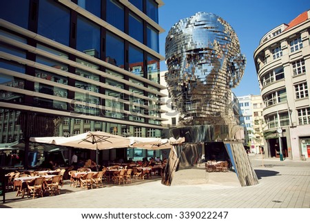 PRAGUE, CZECH REPUBLIC - AUG 29: Outdoor cafe near  famous artist David Cerny\'s sculpture Metalmorphosis in giant head form on August 29 2015. In 1992 Old Prague was listed in UNESCO Heritage Register