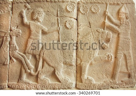 BERLIN, GERMANY - SEPT 2, 2015: 8th century BC bas-relief with great scene with tiger hunters from Assyrian on Septemper 2, 2015. Basalt sculpture from ancient Turkey area is part of Pergamon Museum